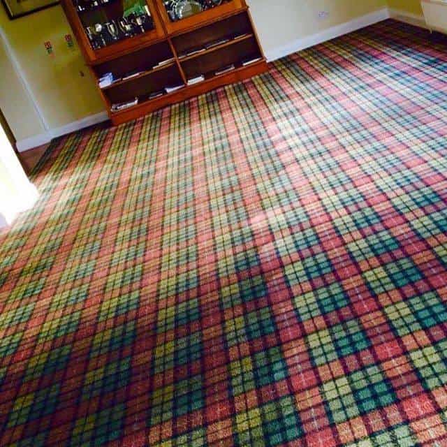 A plaid carpet in a living room.