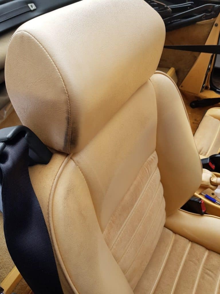 The interior of a car with tan leather seats.
