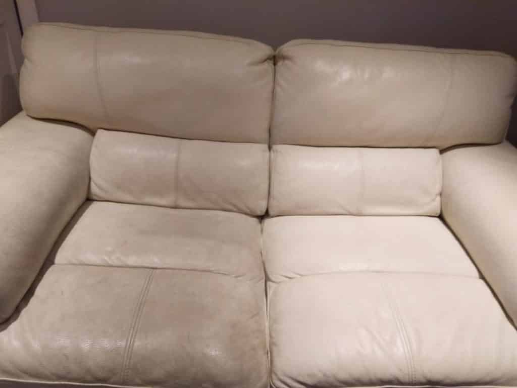 A white leather couch in a room.
